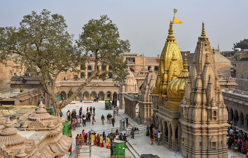 Kashi Vishwanath Temple in Varanasi with golden spires under clear sky