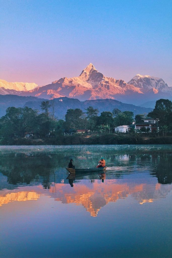 Boating on Phewa Lake with the World Peace Pagoda and mountains in the background