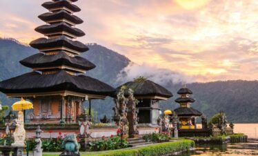 Silhouette of a Bali temple against a vivid red sunset sky