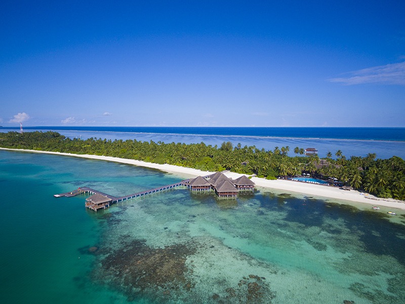 Drone view of an exclusive water villa in Maldives with private deck over the ocean
