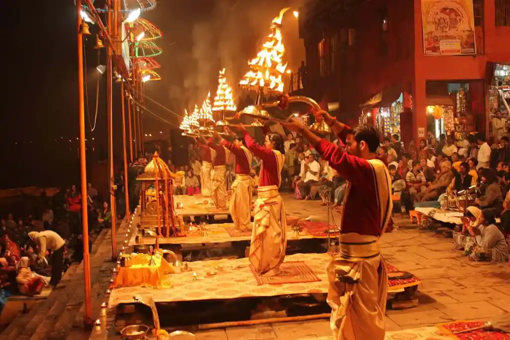 Ganga Aarti ceremony in Varanasi with priests holding lit lamps at Dashashwamedh Ghat
