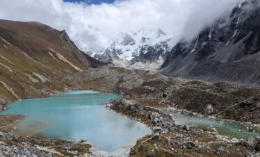 Crystal clear Dudhkunda Lake reflecting surrounding Himalayan mountains in Dolakha, Nepal