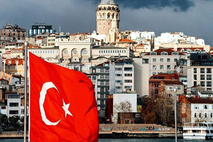 Panoramic view of Istanbul city with the Turkish flag waving