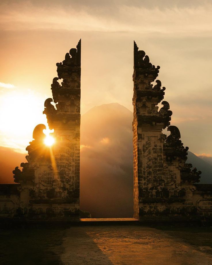 Sunset view from Lempuyang Temple in Bali with vibrant orange and pink skies over mountains