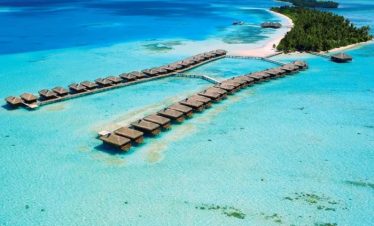 Aerial view of luxurious water villas in the Maldives over turquoise ocean