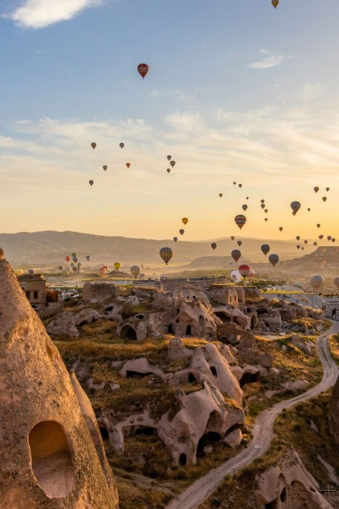 Hot air balloons floating over the unique rock formations of Cappadocia, Turkey