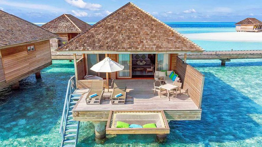 Maldives water villa with sun deck, loungers, and direct sea access