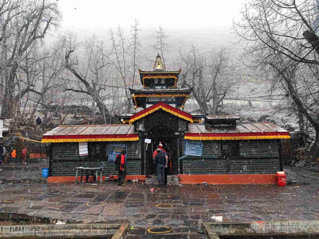 Muktinath Temple with pilgrims and Himalayan mountains in the background, Mustang, Nepal