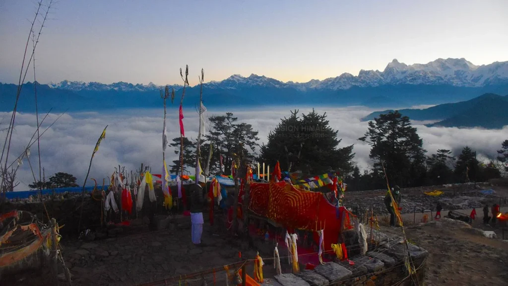 Pathibhara Temple perched atop a hill with Himalayan mountains and clouds in the background