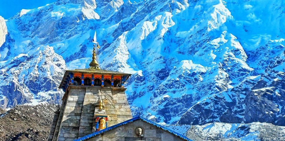 Kedarnath Temple with snow-covered Himalayan mountains during Kedarnath Yatra